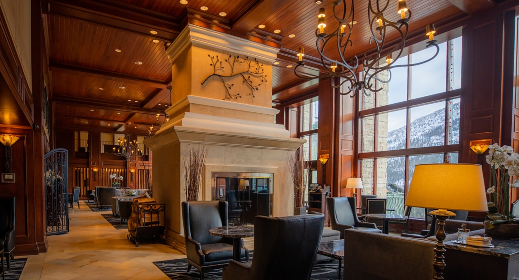 A lobby with lit lamps and big lounge chairs