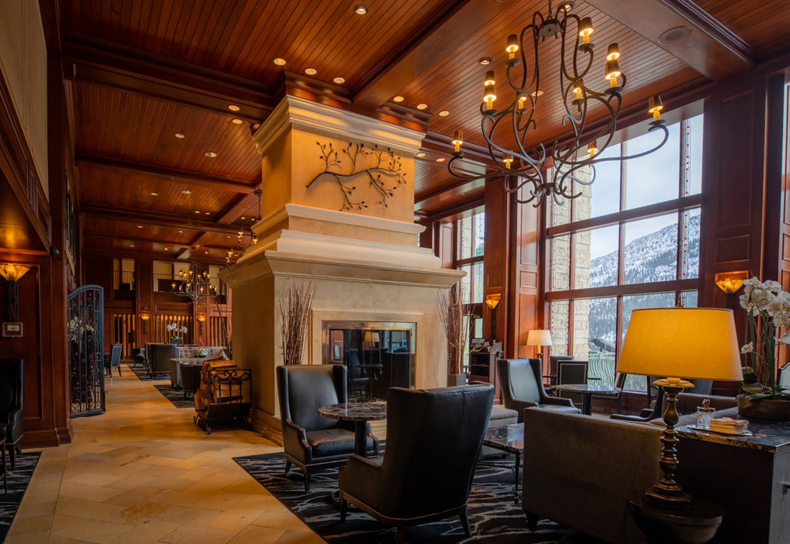 A lobby with lit lamps and big lounge chairs