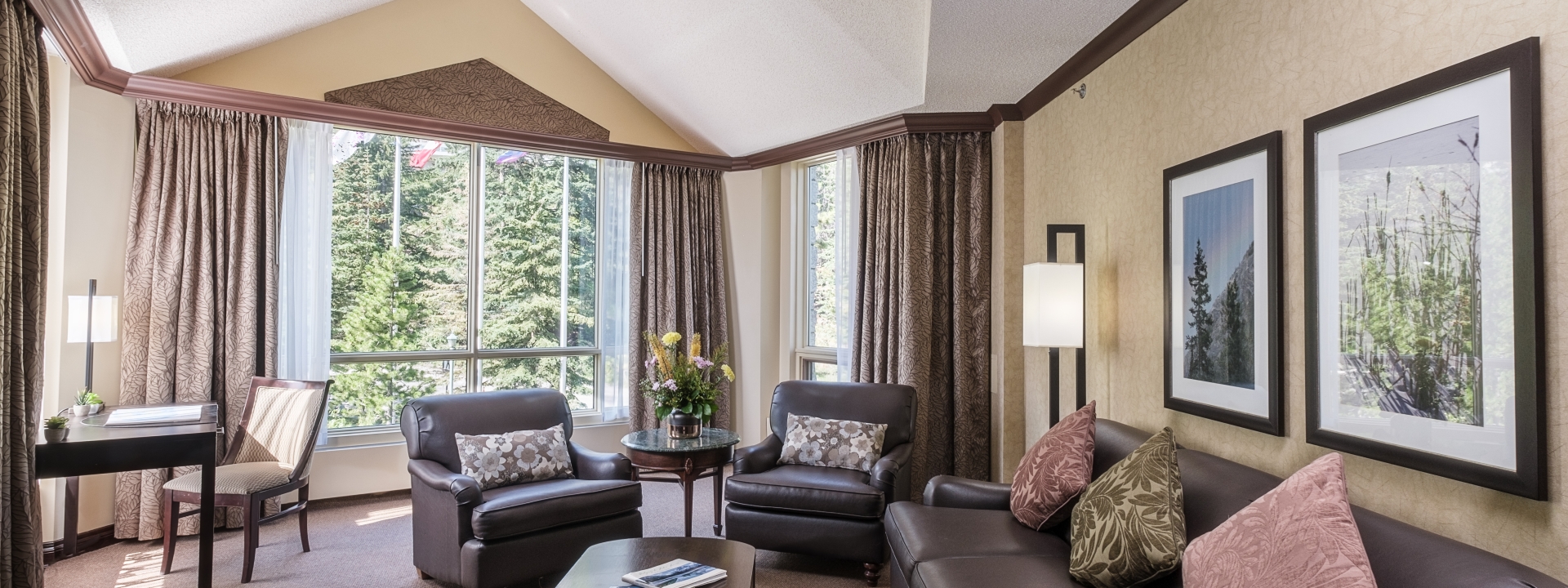 Living area with couch, chairs and a view of trees