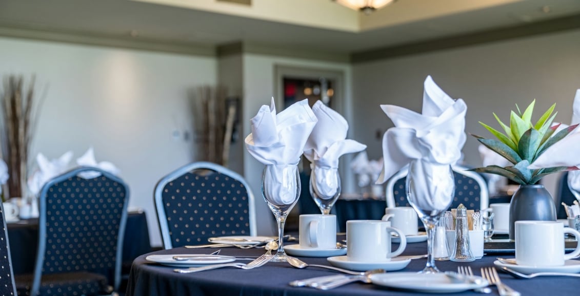 Three wine glasses with napkins in view