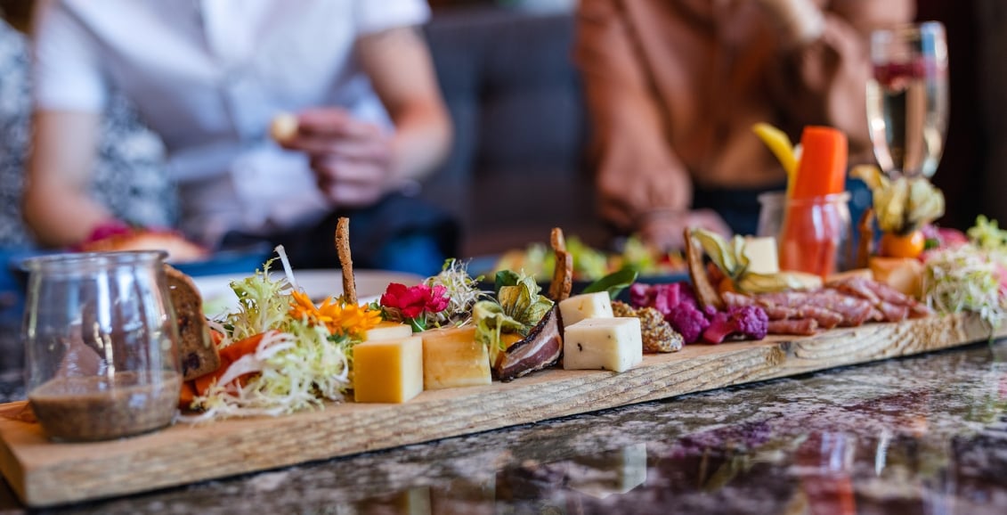 A food board with cheese and vegetables