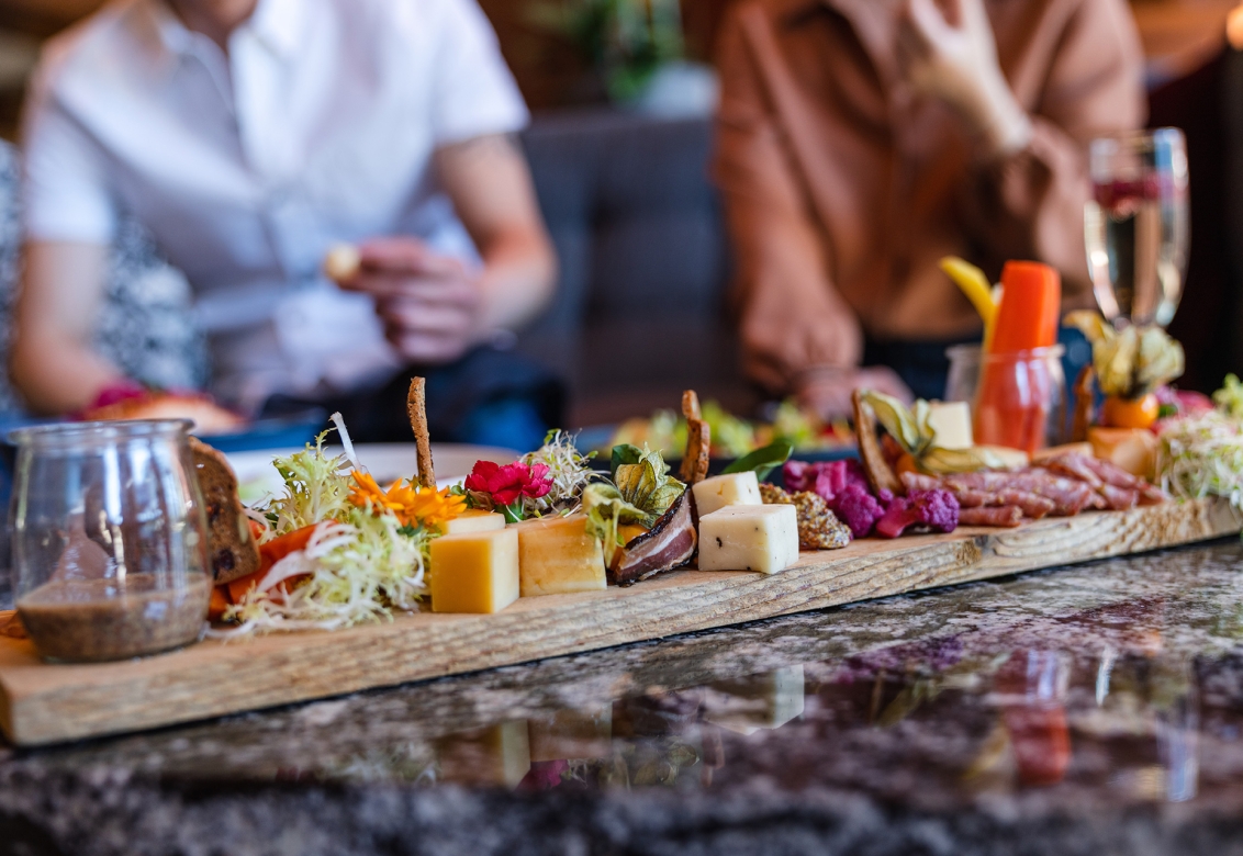 A food board with cheese and vegetables