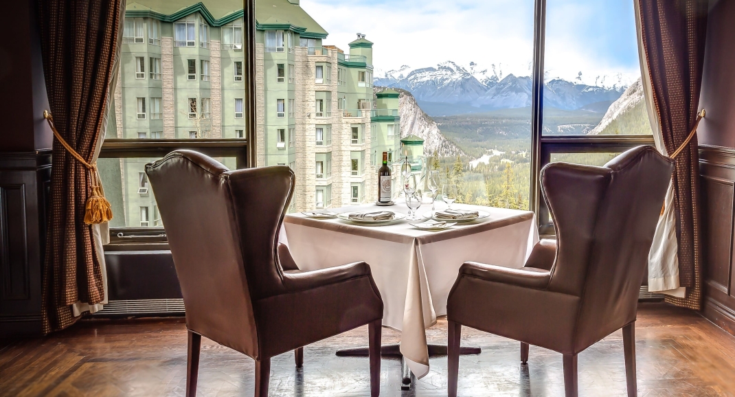 Two chairs facing a view of a mountain