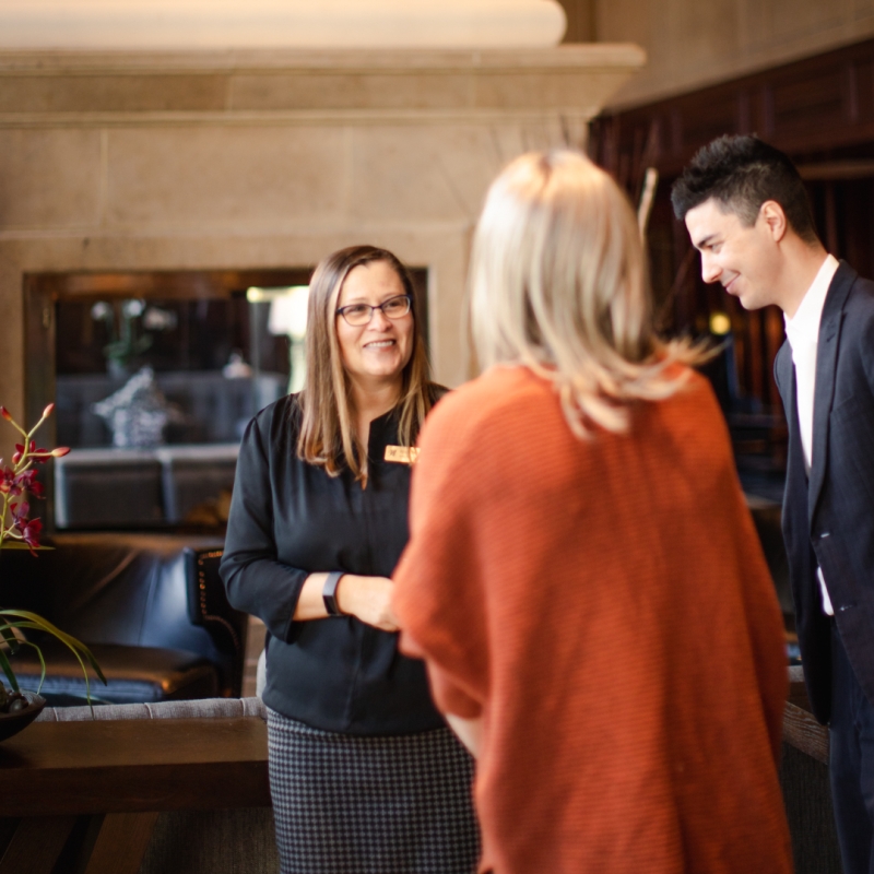 Three people standing and talking