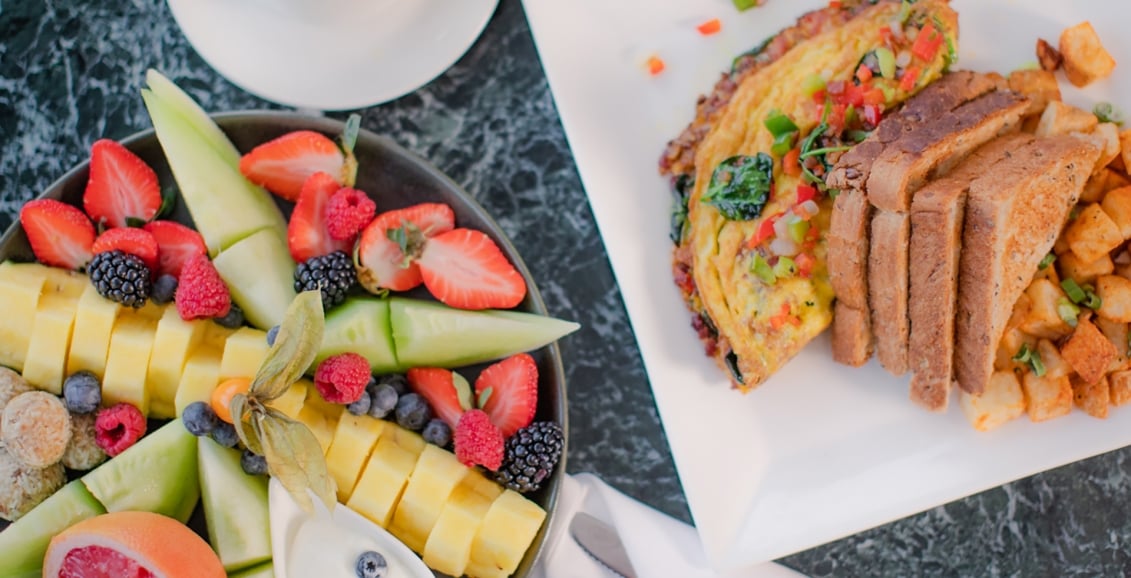 A breakfast spread with fruits and coffee