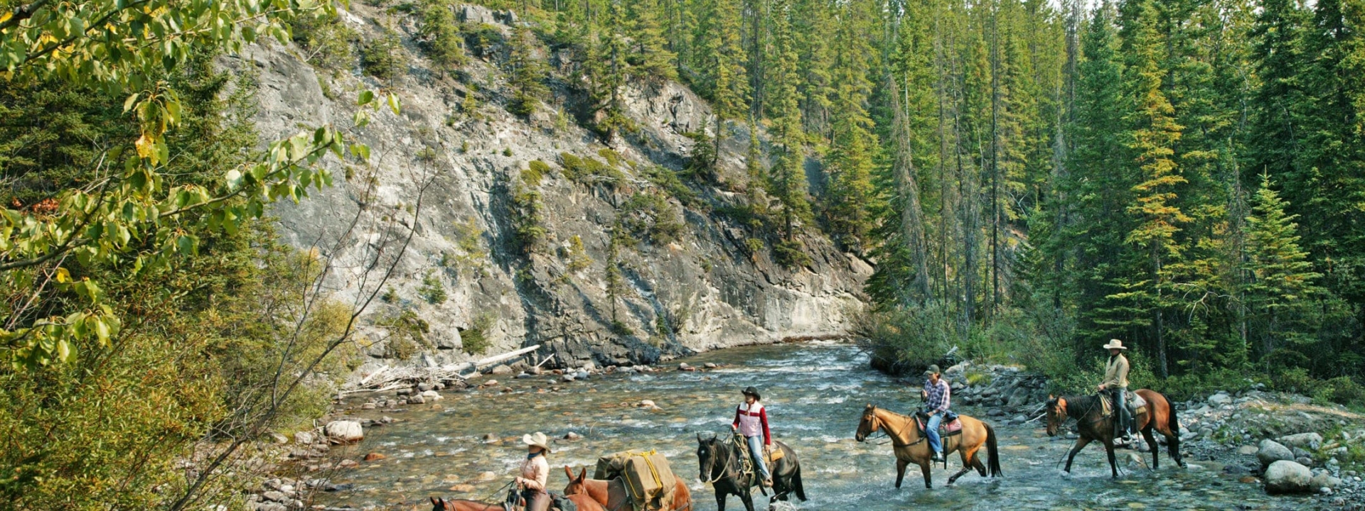 Four people Horseback riding in Banff