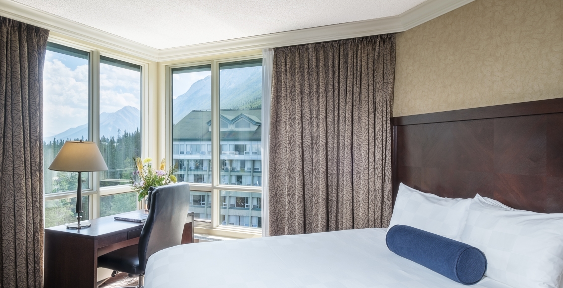 Bed with view of Rimrock Resort hotel