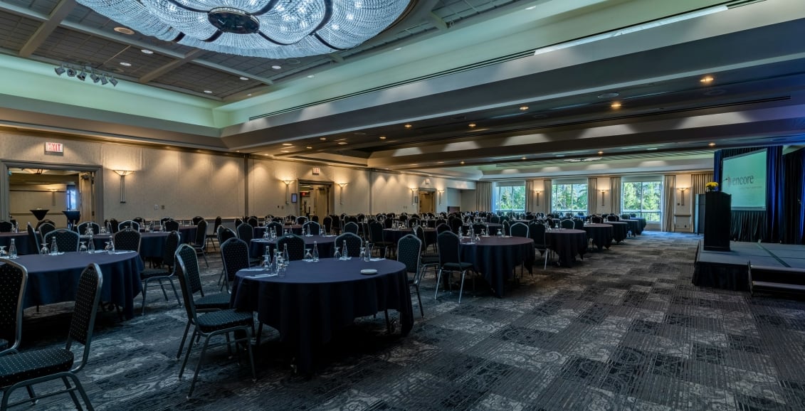 A view of round tables and chairs in a conference room