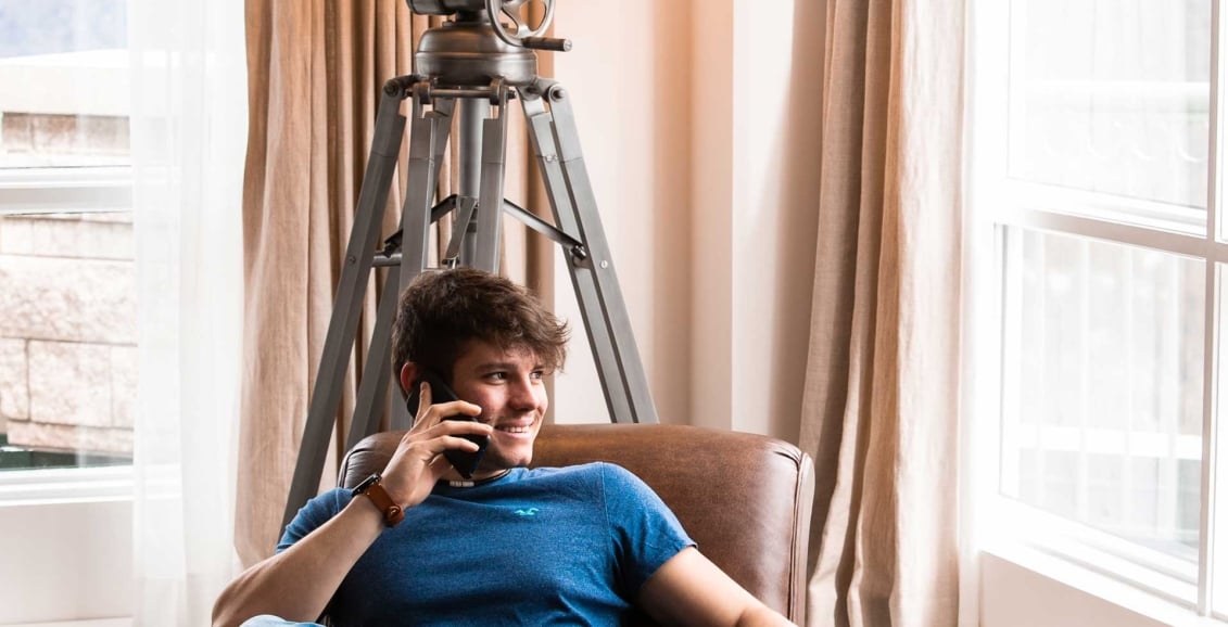 A man sitting on a chair on the telephone