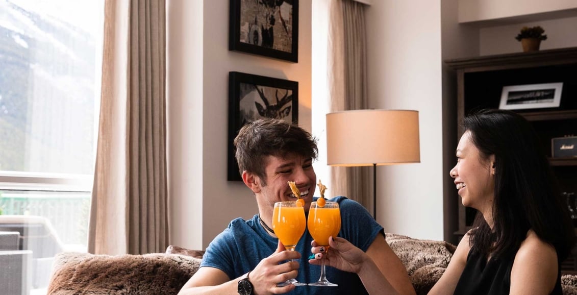 Two people toasting with wine glasses