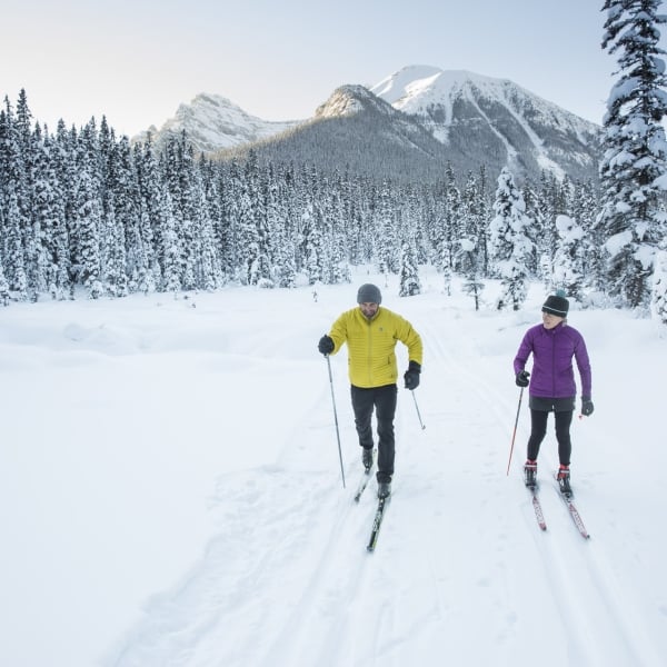 Two people cross country skiing