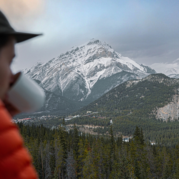 Man looks out over balcony at The Rimrock Resort Hotel at Banff National Park