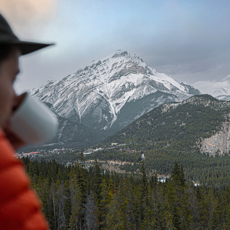 Man looks out over balcony at The Rimrock Resort Hotel at Banff National Park