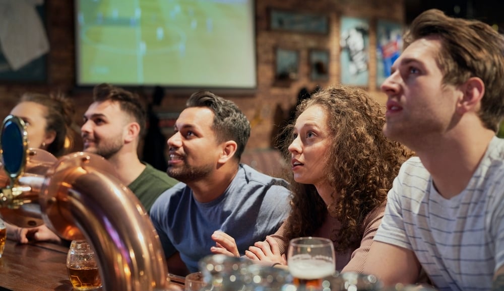 Friends at a bar watching sports