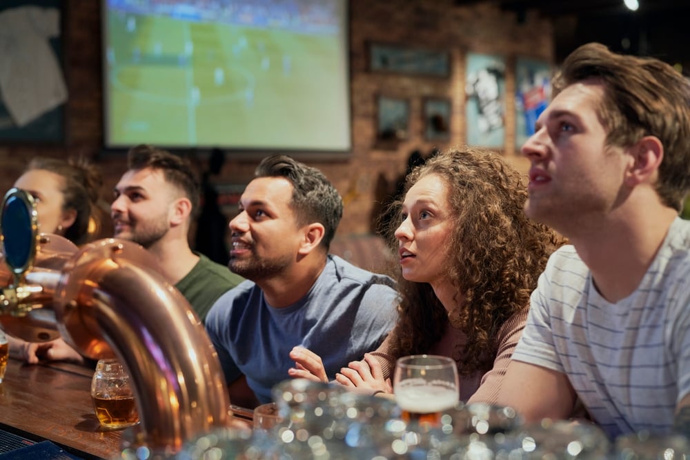 Friends at a bar watching sports