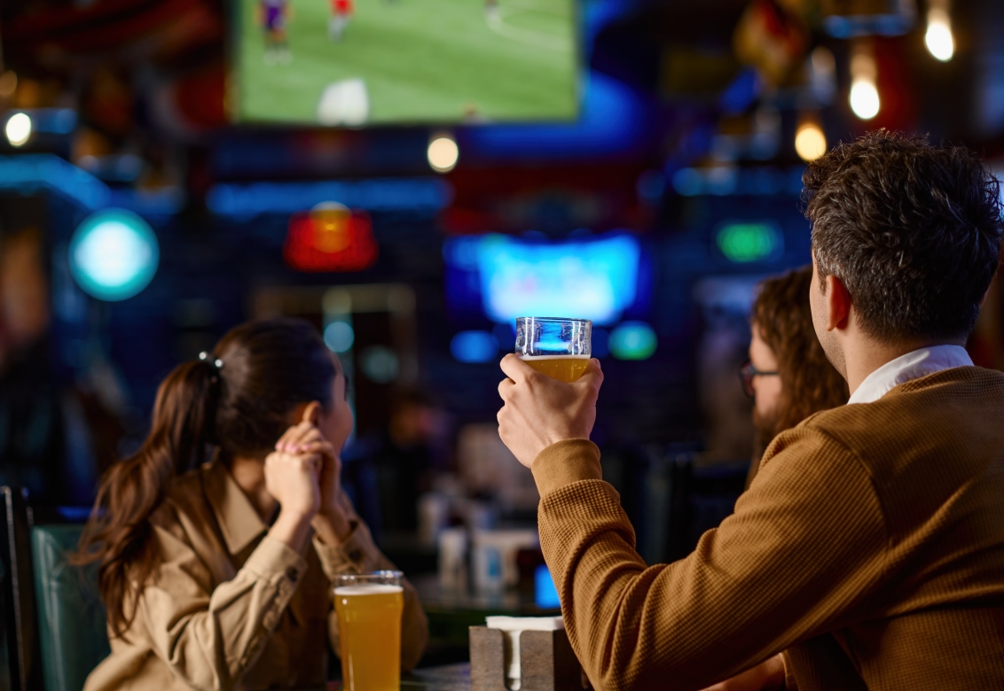 friends watching sports in a bar