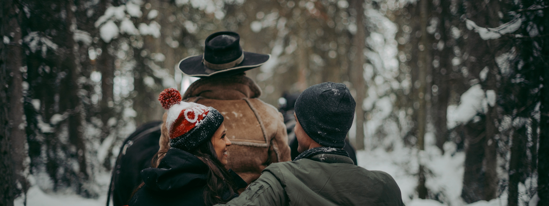 Two people on the back of a sleigh.