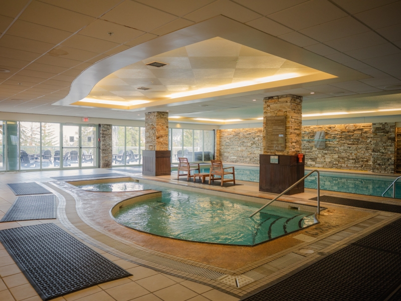 A swimming pool with wooden chairs