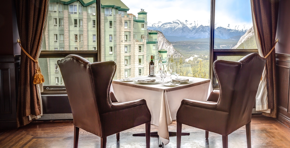 Two arm chairs facing the resort and mountains in the background