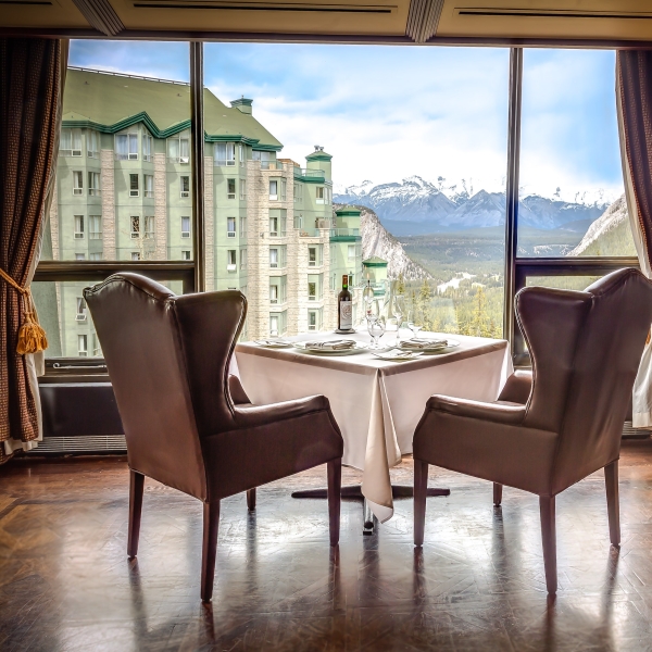 Two arm chairs facing the resort and mountains in the background