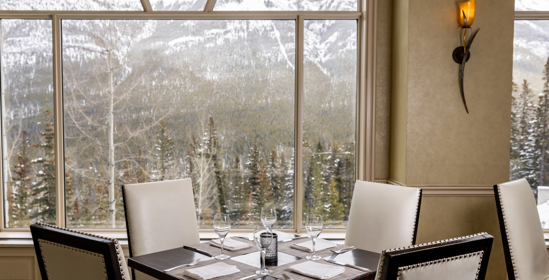 Chairs and a table set with mountains in view