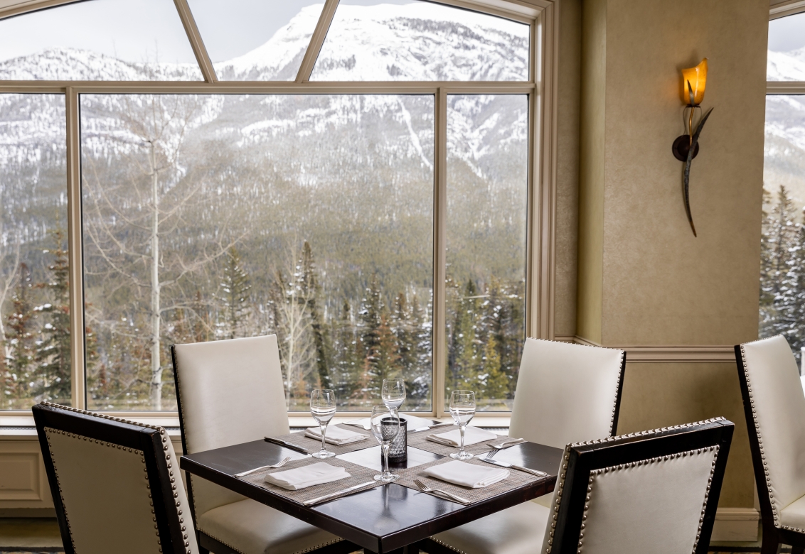 Chairs and a table set with mountains in view