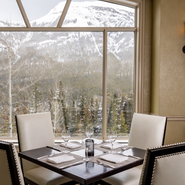 Chairs and a table set with mountains in view