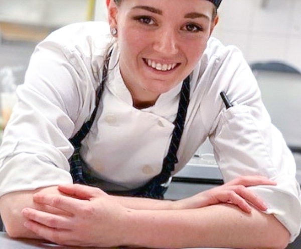 Pastry Chef in front of her creations