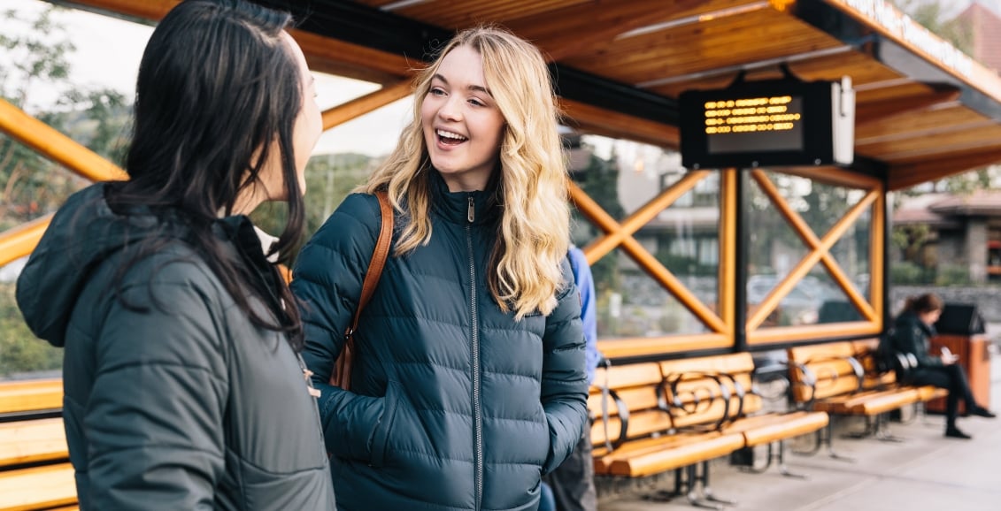 Two ladies waiting for the bus.