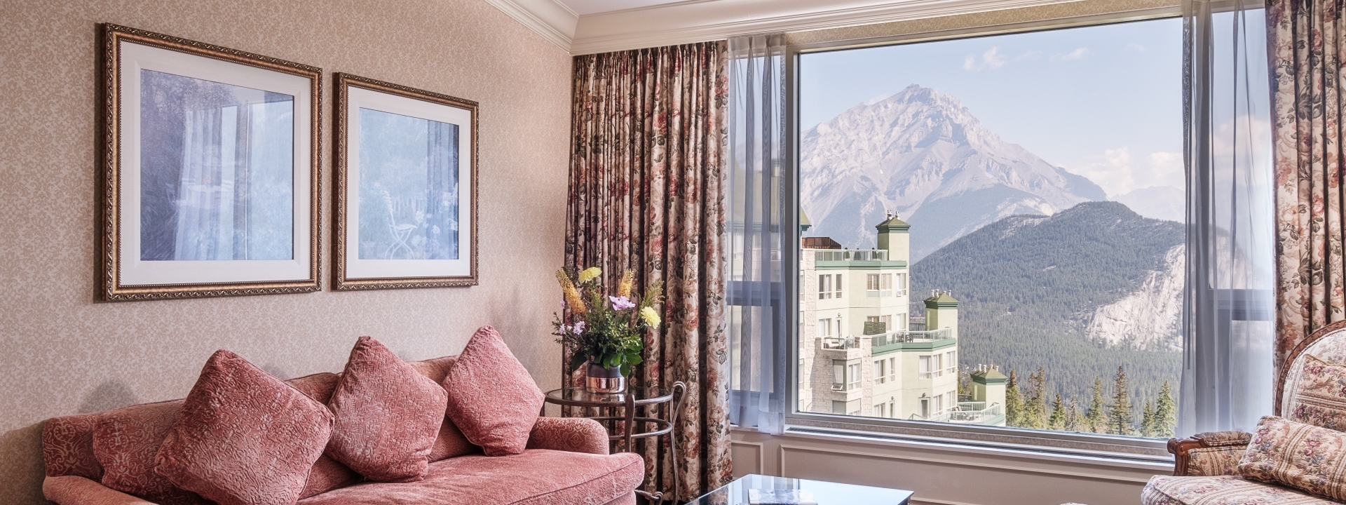 beautiful living room with view of hotel and mountains