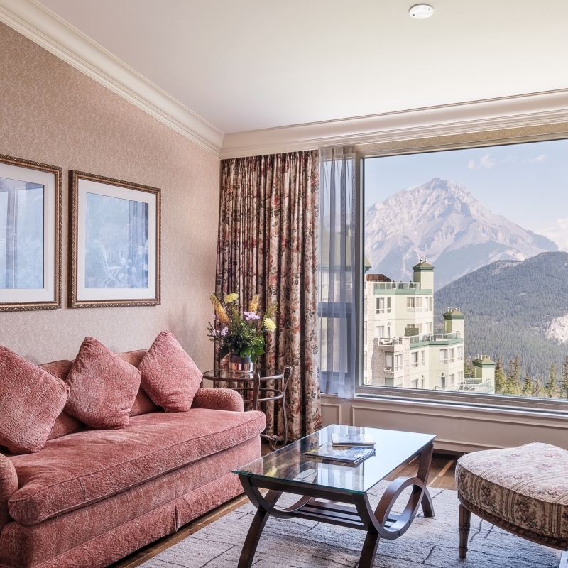 beautiful living room with view of hotel and mountains