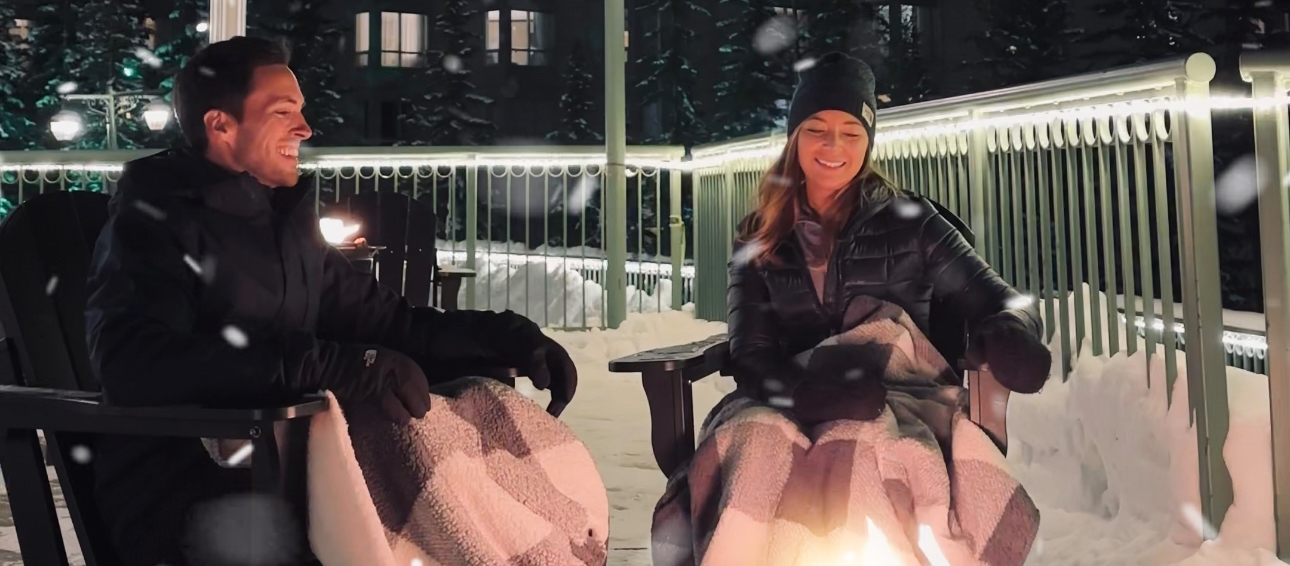 Couple enjoys the outdoor fire pits in Banff National Park at the Rimrock