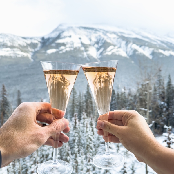 two glasses of champagne snowy backdrop