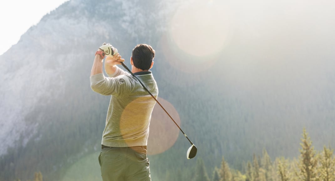 man swinging golf club