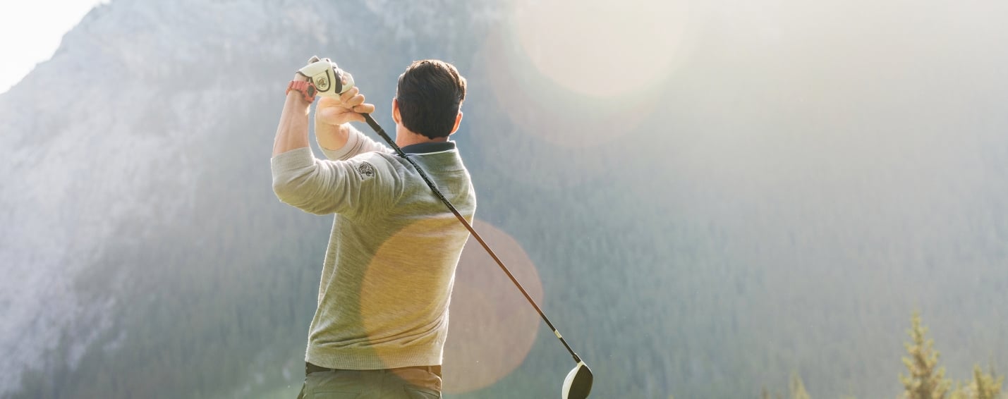 man swinging golf club