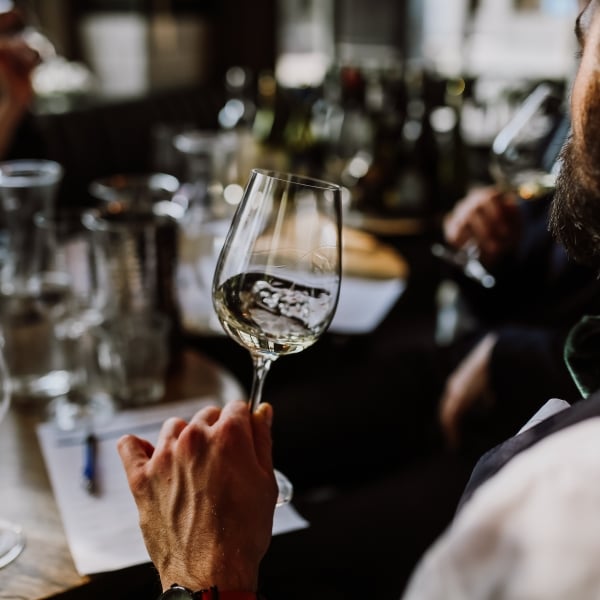 man sniffing wine at wine tasting