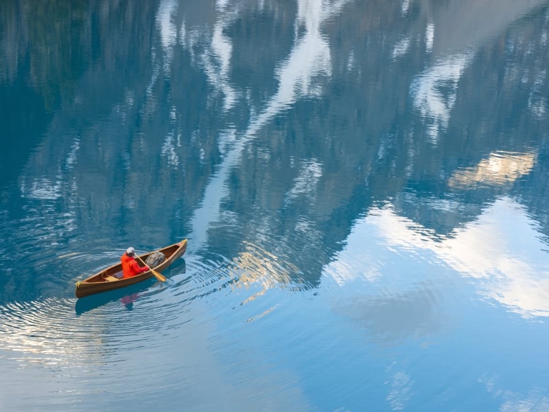 A man canoeing in Moraine Lake