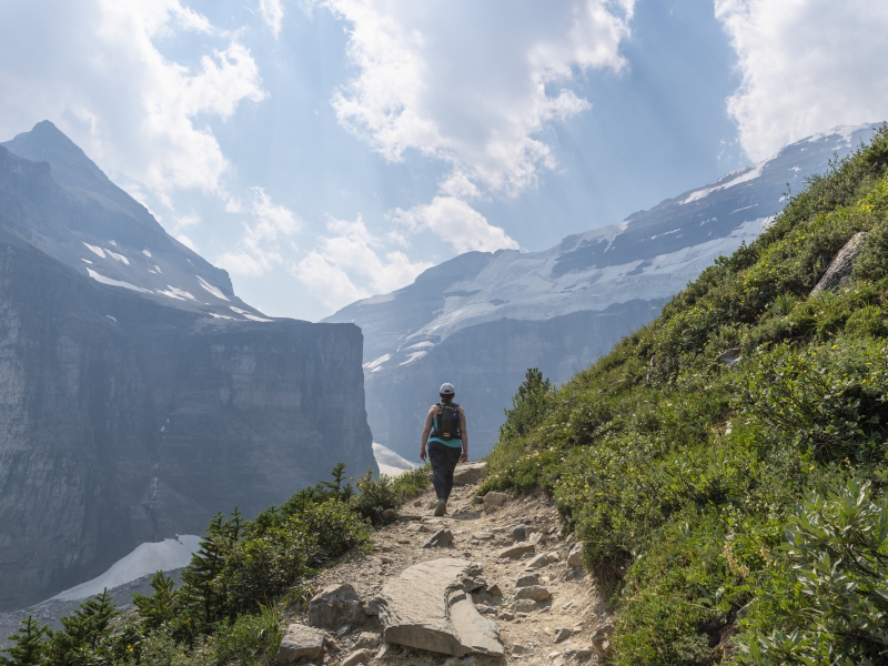 Woman hikes along trail, in Banff National Park