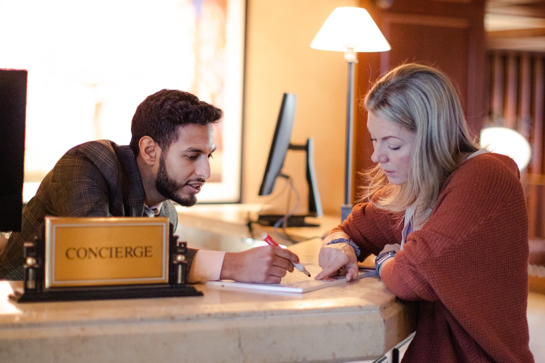 woman and man at a concierge desk