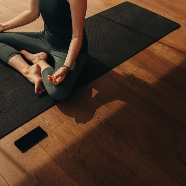 Woman on yoga mat meditating