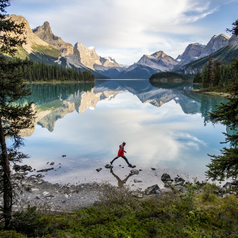 Man hopping rocks in Banff National Park
