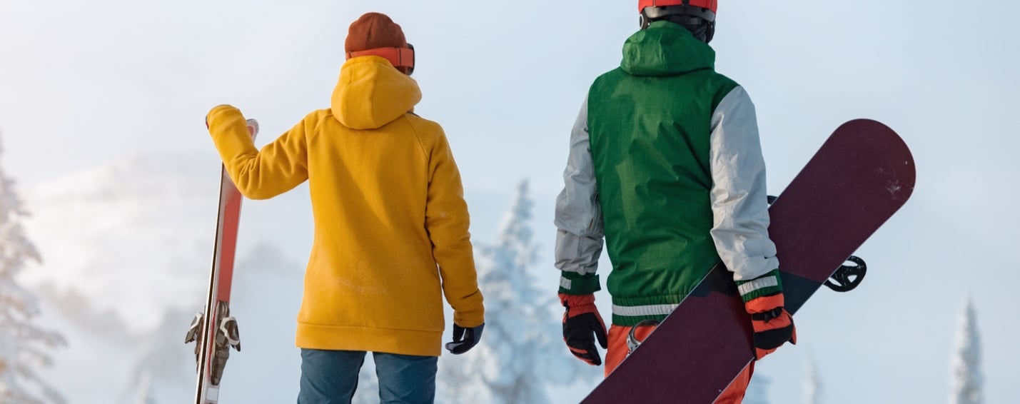 couple standing with ski and snow board in Banff National Park