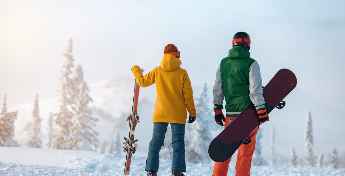 Couple getting ready to ski and snowboard in Banff National Park