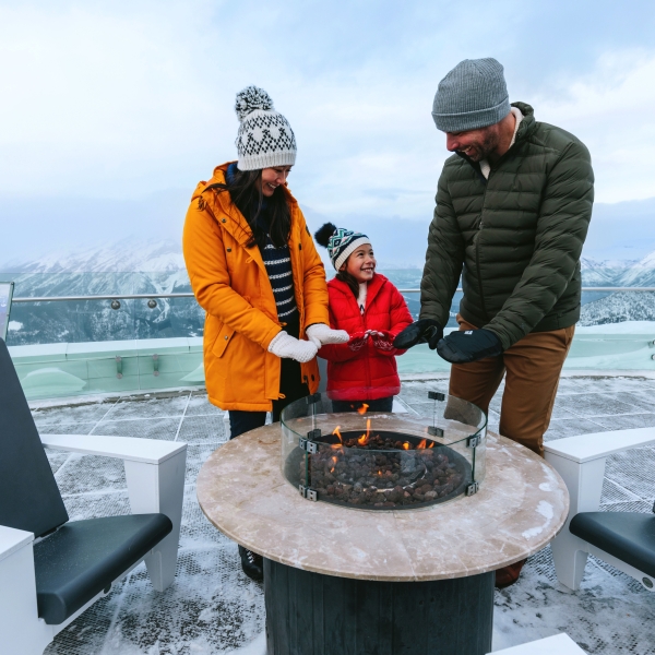 Family warming hands at the Banff Gondola