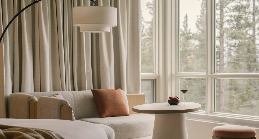 Table and chairs looking out of the view at Rimrock banff with strawberries and wine.