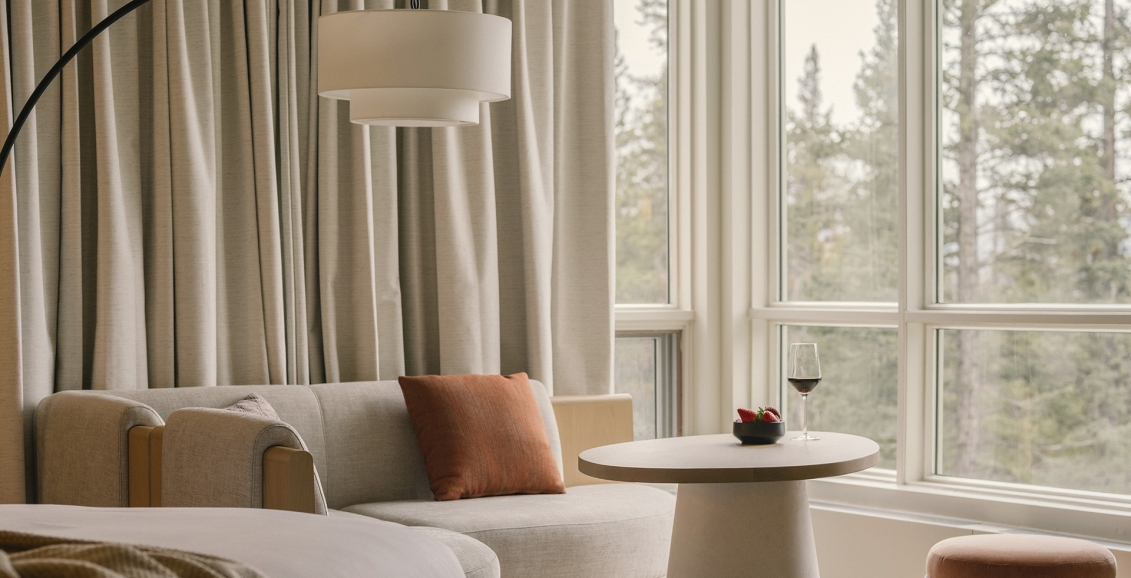 Table and chairs looking out of the view at Rimrock banff with strawberries and wine.