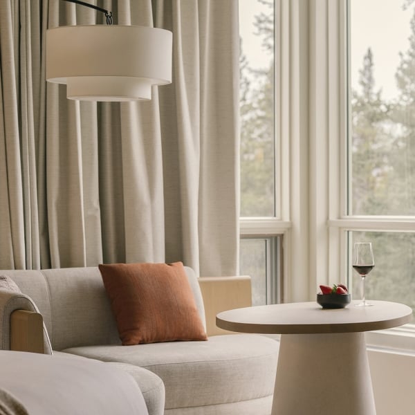 Table and chairs looking out of the view at Rimrock banff with strawberries and wine.