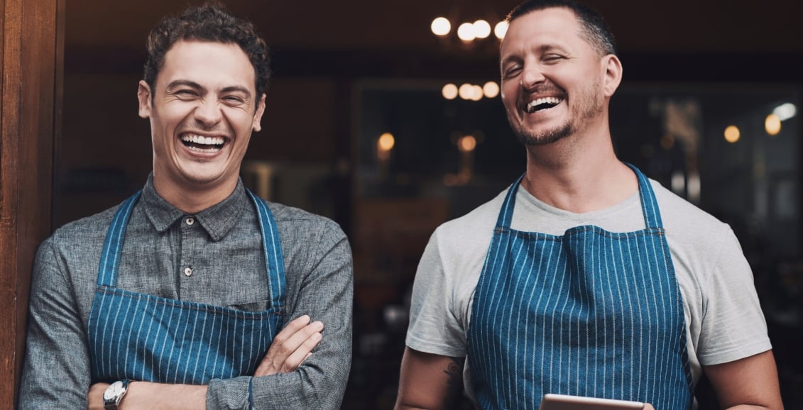 Two staff enjoying a laugh together