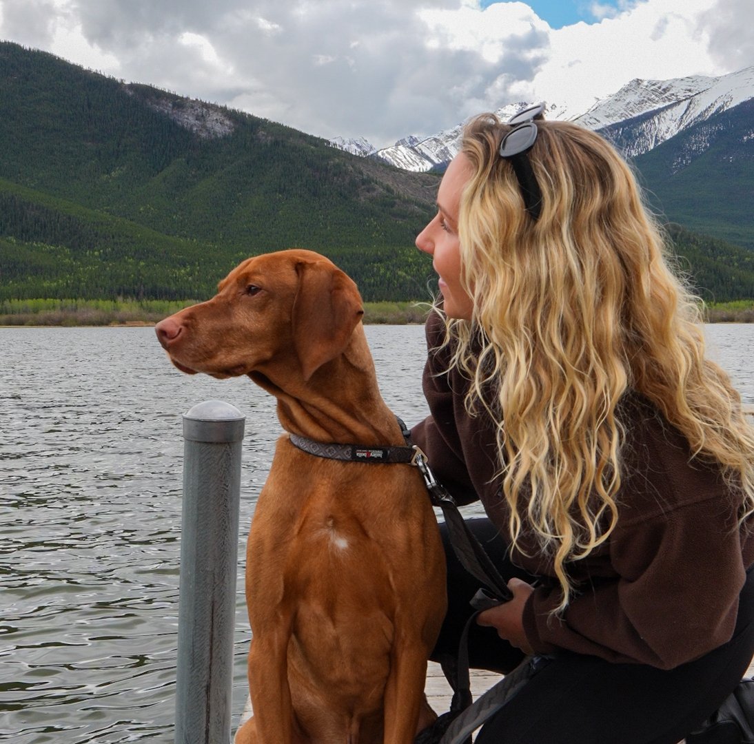 A woman and her dog at Vermillion Lakes in Banff Alberta