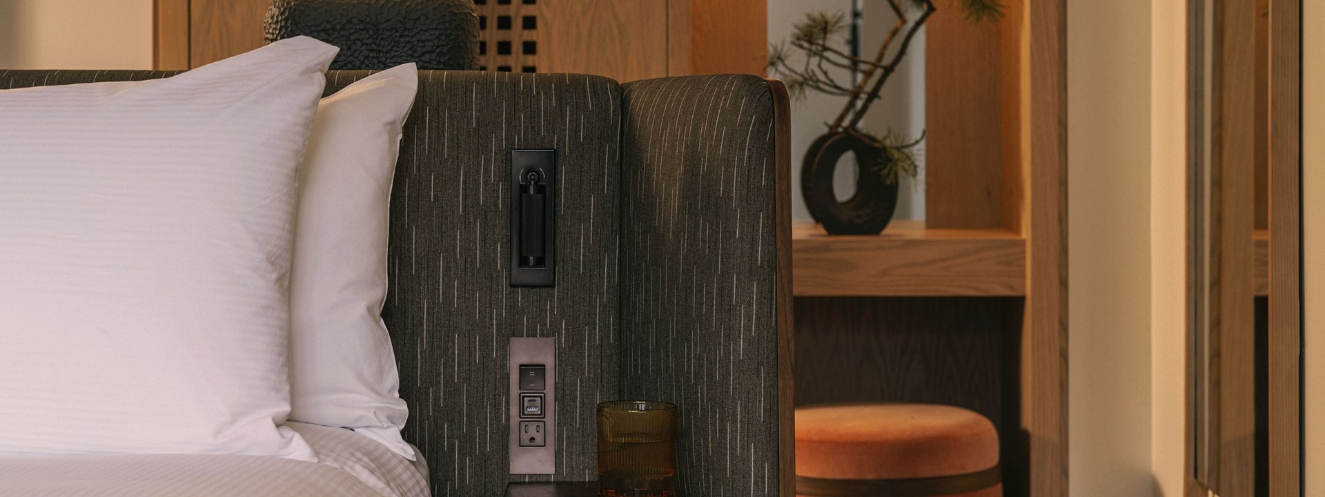 A bed with a vanity in the background in a Valley View Suite at Rimrock Banff, Emblems Collection